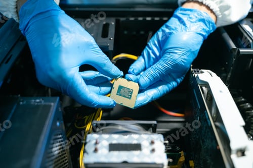 Preview: The technician is putting the CPU on the socket of the computer motherboard. electronic engineering