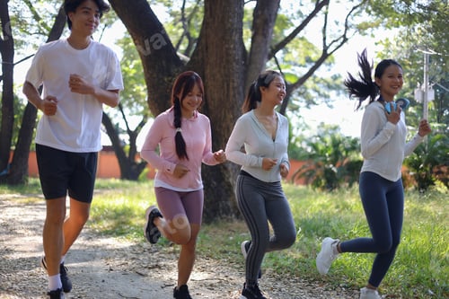 Preview: Group of Young Adults Jogging in Park