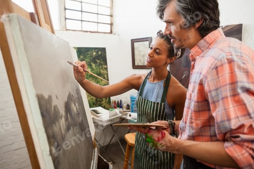 Preview: Man assisting woman in painting