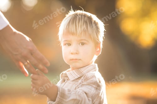 Preview: Autumn portrait of 2-3 years old child in garden. Fall season. Close-up view of cheerful sweet boy