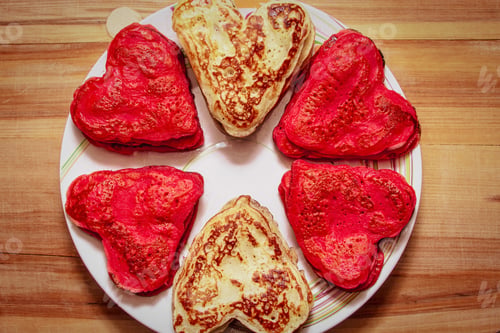 Preview: Red heart shaped pancakes made with love for valentines day and tulips on wooden background