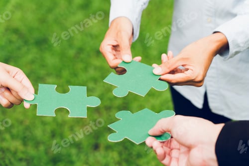Preview: group of business people assembling jigsaw puzzle. The concept of cooperation