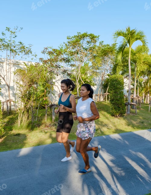 Preview: Two Asian women exercise running in a public park in Pattaya Thailand. Female friends jogging