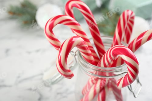 Preview: Sweet Christmas candy canes in glass jar, closeup
