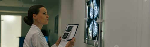 Preview: Side view of professional doctor radiologist analyzing scan MRI images in medical center