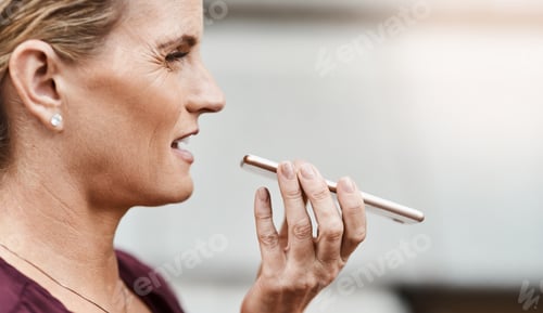 Preview: Shot of a mature businesswoman using a smartphone against an urban background