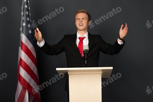 Preview: happy emotional man on tribune with american flag on black background