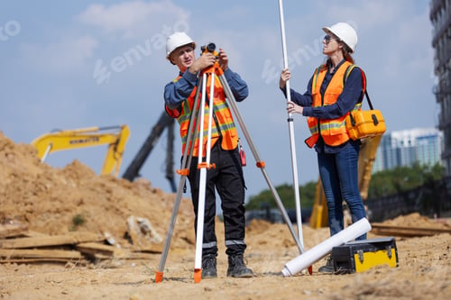 Preview: Two construction surveyors using a tripod-mounted total station