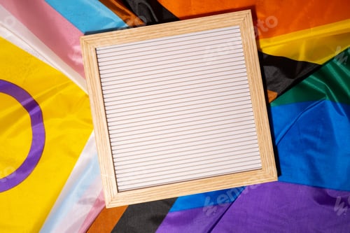 Preview: Empty blank frame on Rainbow LGBTQIA flag made from silk material with copy space for your text