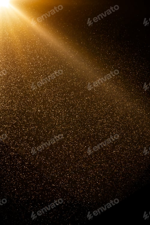 Preview: Golden particles falling from bright light beam on black background