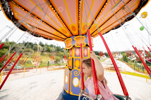 Preview: Kids riding on colorful amusement carousel