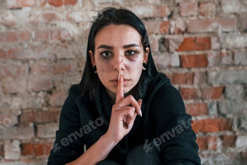 Preview: Portrait of beaten young woman with bruise under eye indoors in abandoned building
