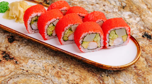 Preview: Colorful sushi rolls served on a white plate with garnishes