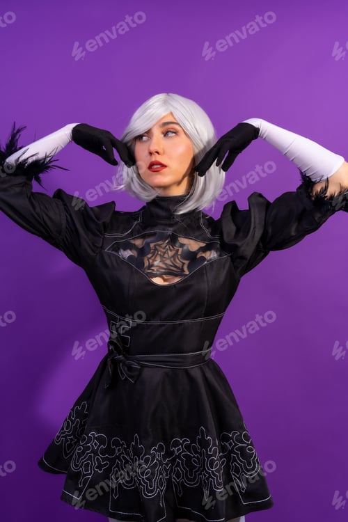 Preview: Portrait of cosplay woman in a black costume and a white wig in studio on a purple background