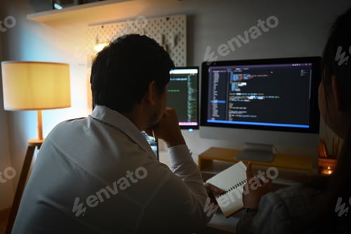 Preview: Team of coders brainstorming ideas for developing website design in office at night