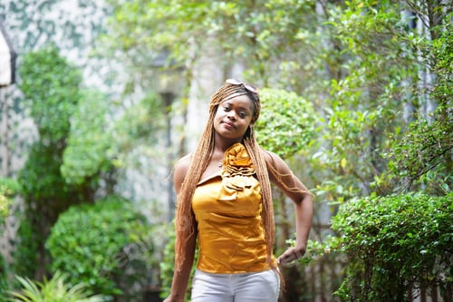 Preview: Woman in Yellow Top Poses Outdoors