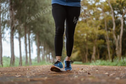 Preview: A woman Jogging in the natural park. Legs close up.