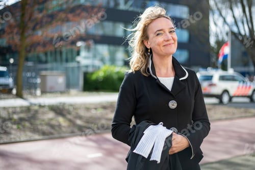 Preview: Young professional woman standing in public smiling happy walking to work