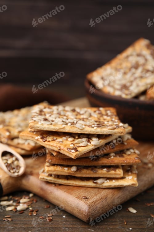 Preview: Cereal crackers with flax, sunflower and sesame seeds on wooden table, closeup