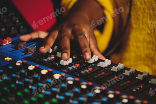 Preview: Unrecognizable sound engineer working on mixing console
