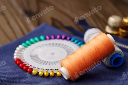 Preview: Threads and sewing accessories on brown wooden table