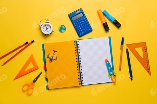Preview: Colorful school supplies on yellow background.