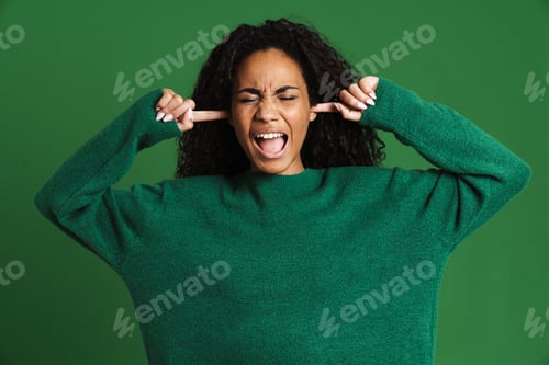 Preview: Young black woman screaming while plugging her ears