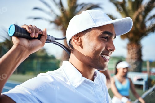Preview: Shot of a handsome young man standing and holding a tennis racket during practice