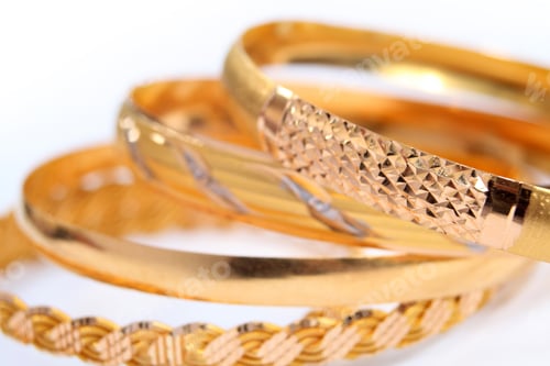 Preview: various gold bracelets on a white background