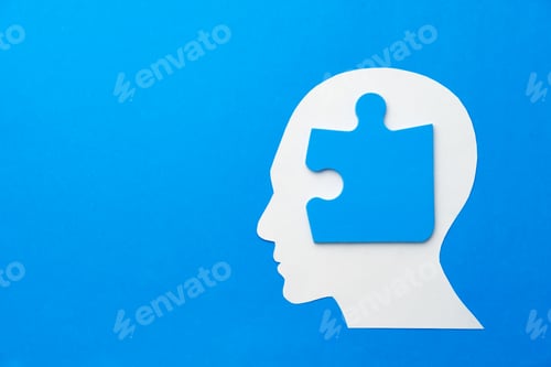 Preview: Papercut head with jigsaw puzzle pieces on blue background