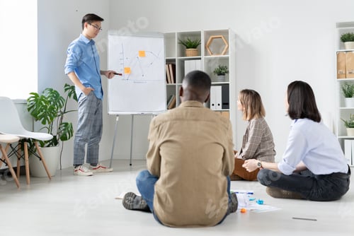 Preview: Young businessman of Chinese ethnicity making presentation of financial graph