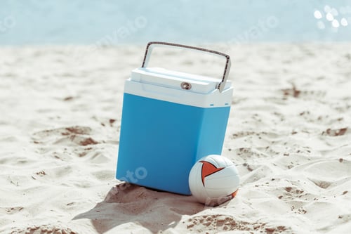 Preview: blue cooler box and volleyball ball on sandy beach