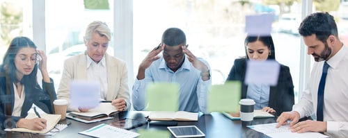 Preview: Shot of a group of businesspeople looking stressed out while working together in an office