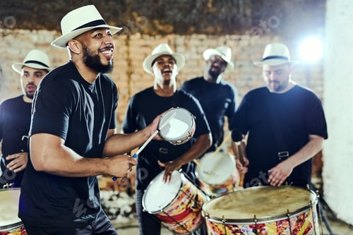 Preview: Feeling the rhythm in the drums. Shot of a group of musical performers playing together indoors.