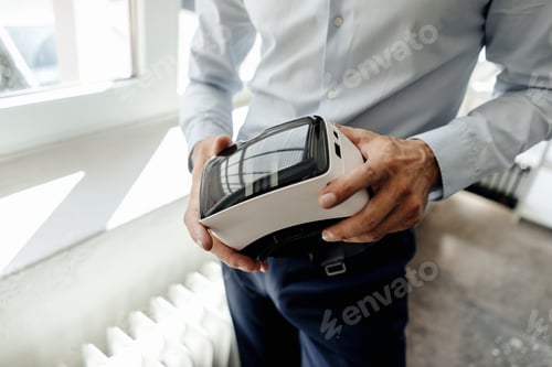 Preview: Businessman holding VR glasses