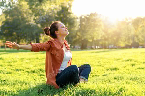 Preview: Young adult woman enjoying outdoor relaxation in city park