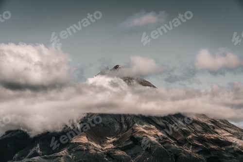 Preview: beautiful landscape of sky and storm clouds over the foot of an impressive mountain with highlights