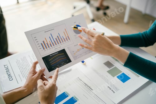 Preview: Two people are looking at a graph on a table
