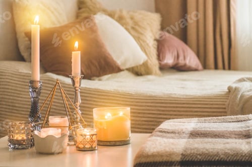 Preview: A lot of candles with candlesticks on the home background. Home and home decor. Candles flame