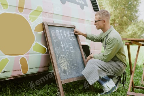 Preview: Caucasian Man Squatting while Writing on Blackboard