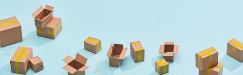 Preview: panoramic view of miniature postal boxes with yellow adhesive tape on blue background