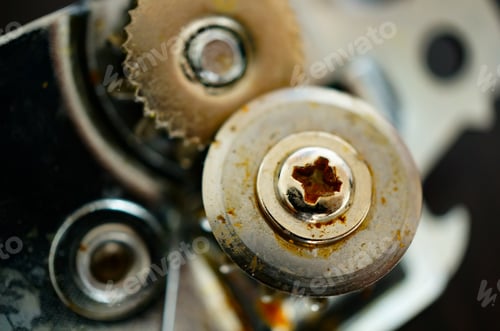 Preview: Top view closeup of a rusty metallic part of the can opener on a blurry background