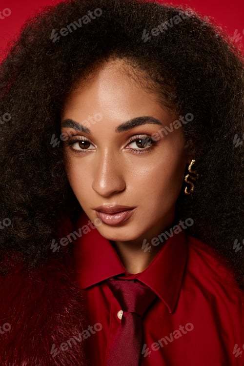 Preview: Stylish african american woman showcases autumn fashion in vibrant studio setting
