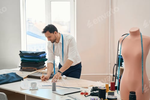 Preview: Male dressmaker making new designs in own atelier