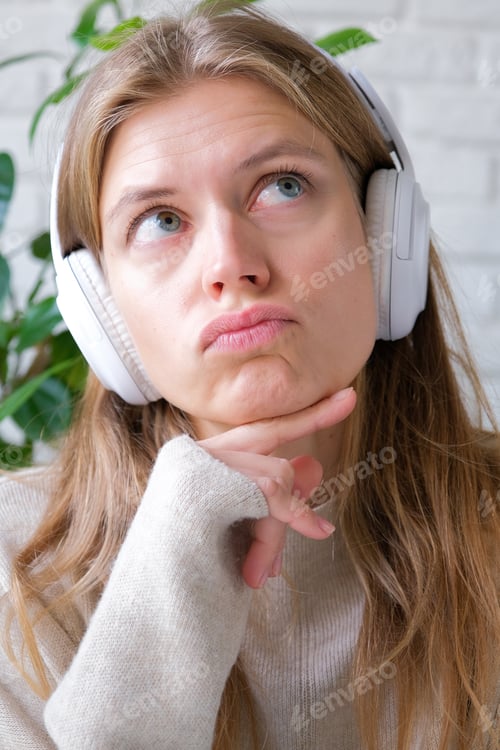 Preview: millennial woman using laptop for work sitting at table at home
