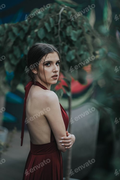 Preview: Portrait of a young woman wearing a red dress in a garden in Bosnia and Herzegovina