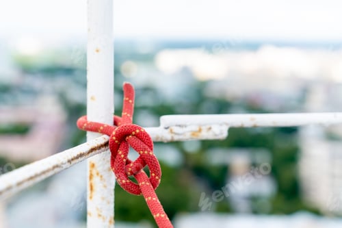 Preview: The safety rope is tied with a strong knot. Work at a high-rise facility.