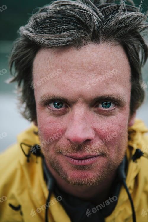 Preview: Portrait of smiling middle aged man in a yellow jacket outdoors