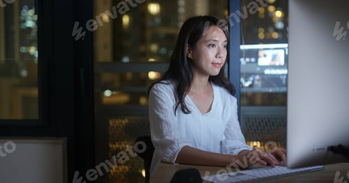 Preview: Woman work on computer at night