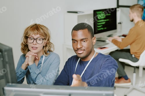 Preview: Man and Woman Working Together in Modern Office